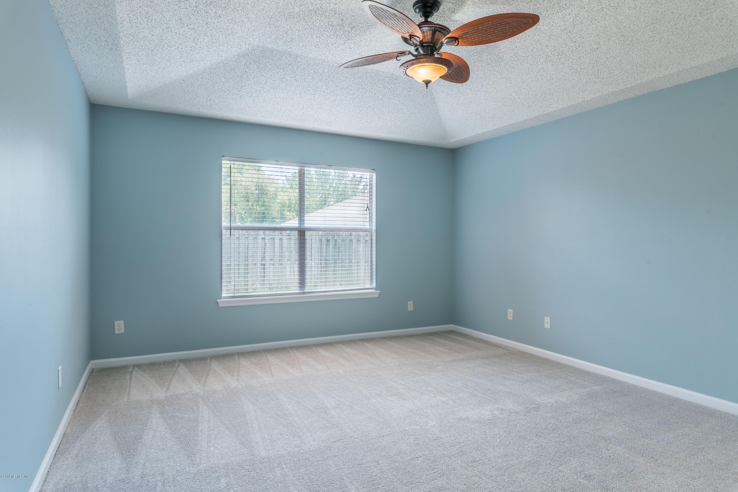 10368 Sugar Grove Road Jacksonville, FL 32221 - Photo 13 of 28 an empty room with windows and fan