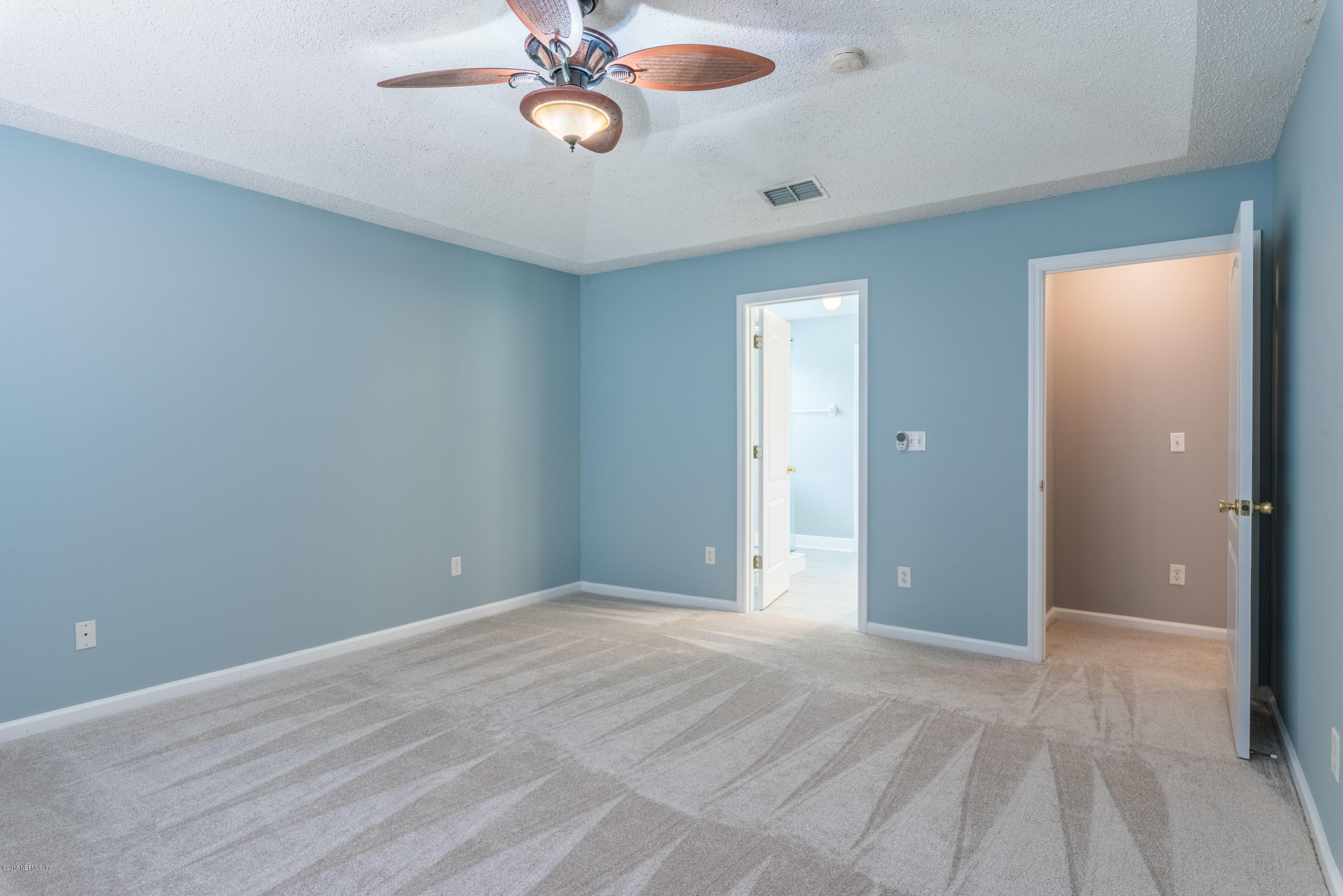 10368 Sugar Grove Road Jacksonville, FL 32221 - Photo 14 of 28 a view of an empty room with a chandelier fan
