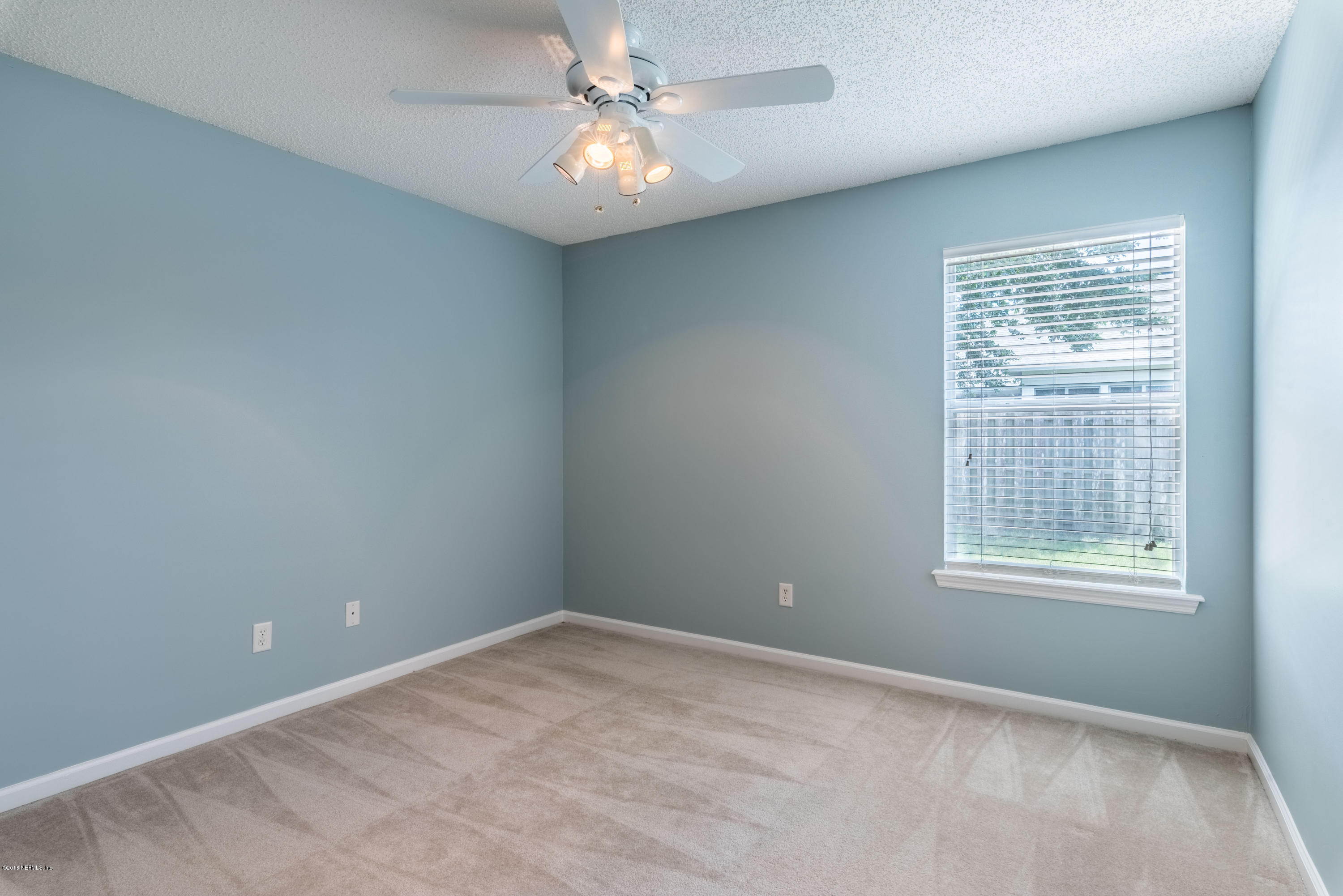 10368 Sugar Grove Road Jacksonville, FL 32221 - Photo 17 of 28 an empty room with windows and fan