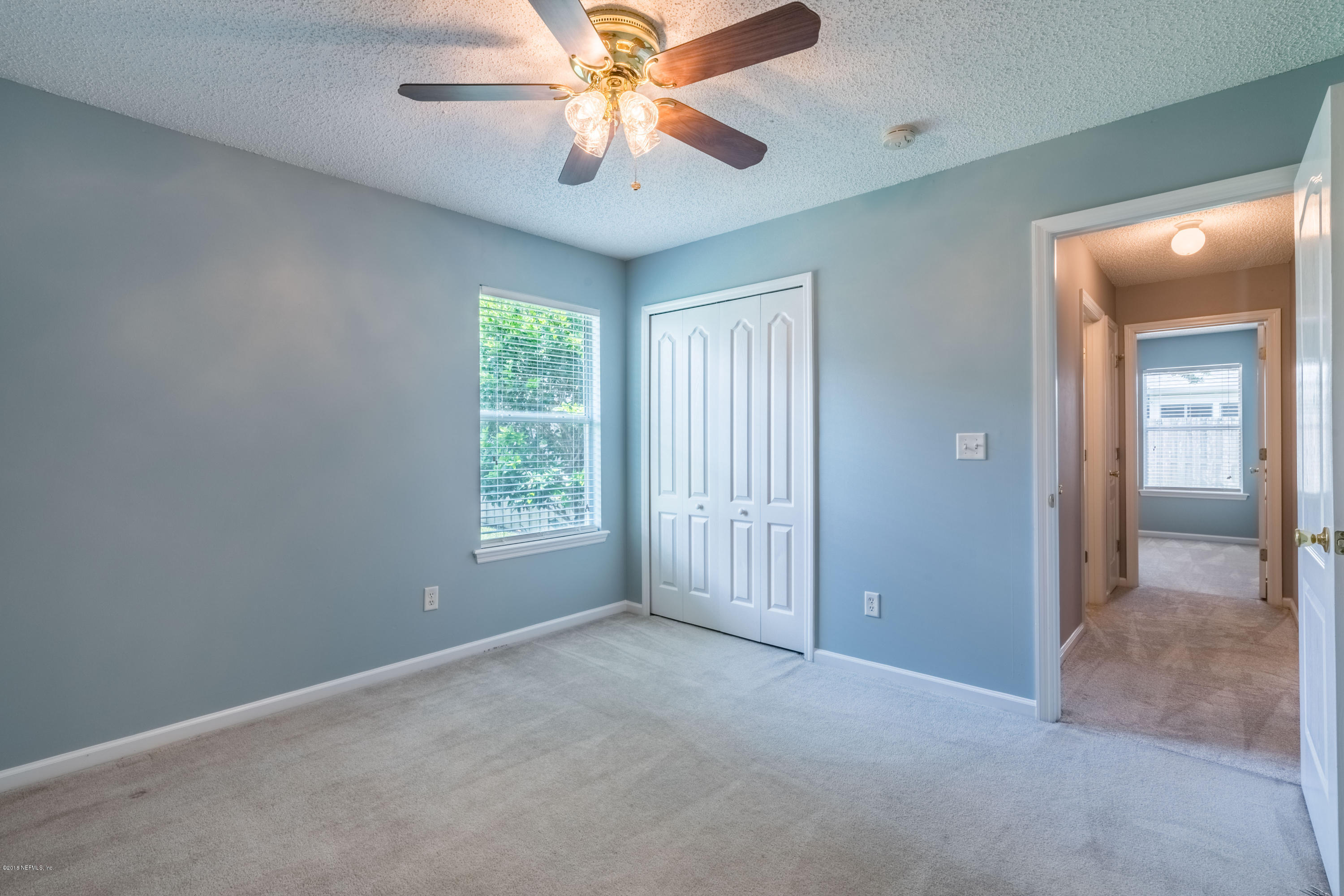 10368 Sugar Grove Road Jacksonville, FL 32221 - Photo 19 of 28 an empty room with windows and fan