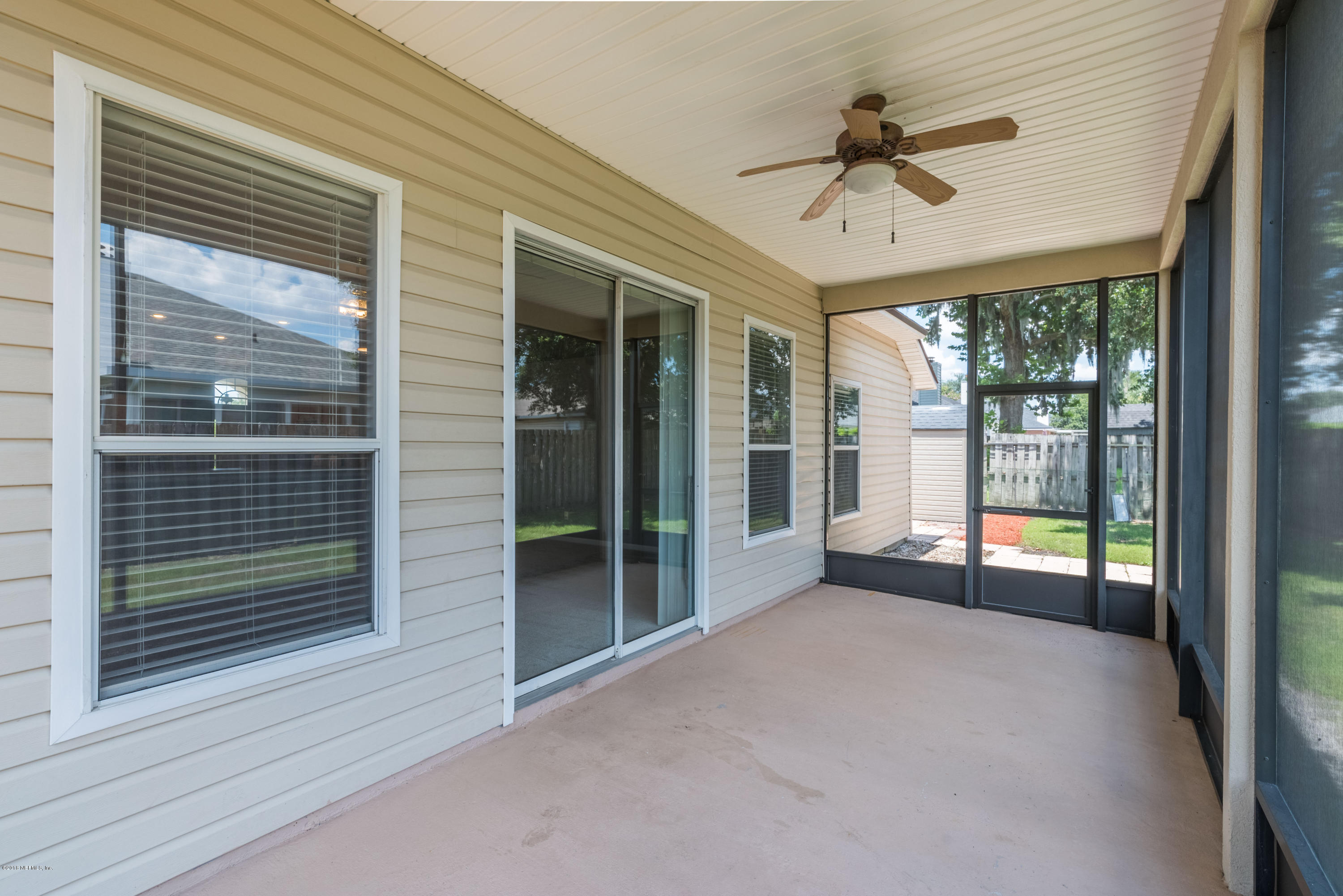 10368 Sugar Grove Road Jacksonville, FL 32221 - Photo 21 of 28 a view of a livingroom with a ceiling fan and window