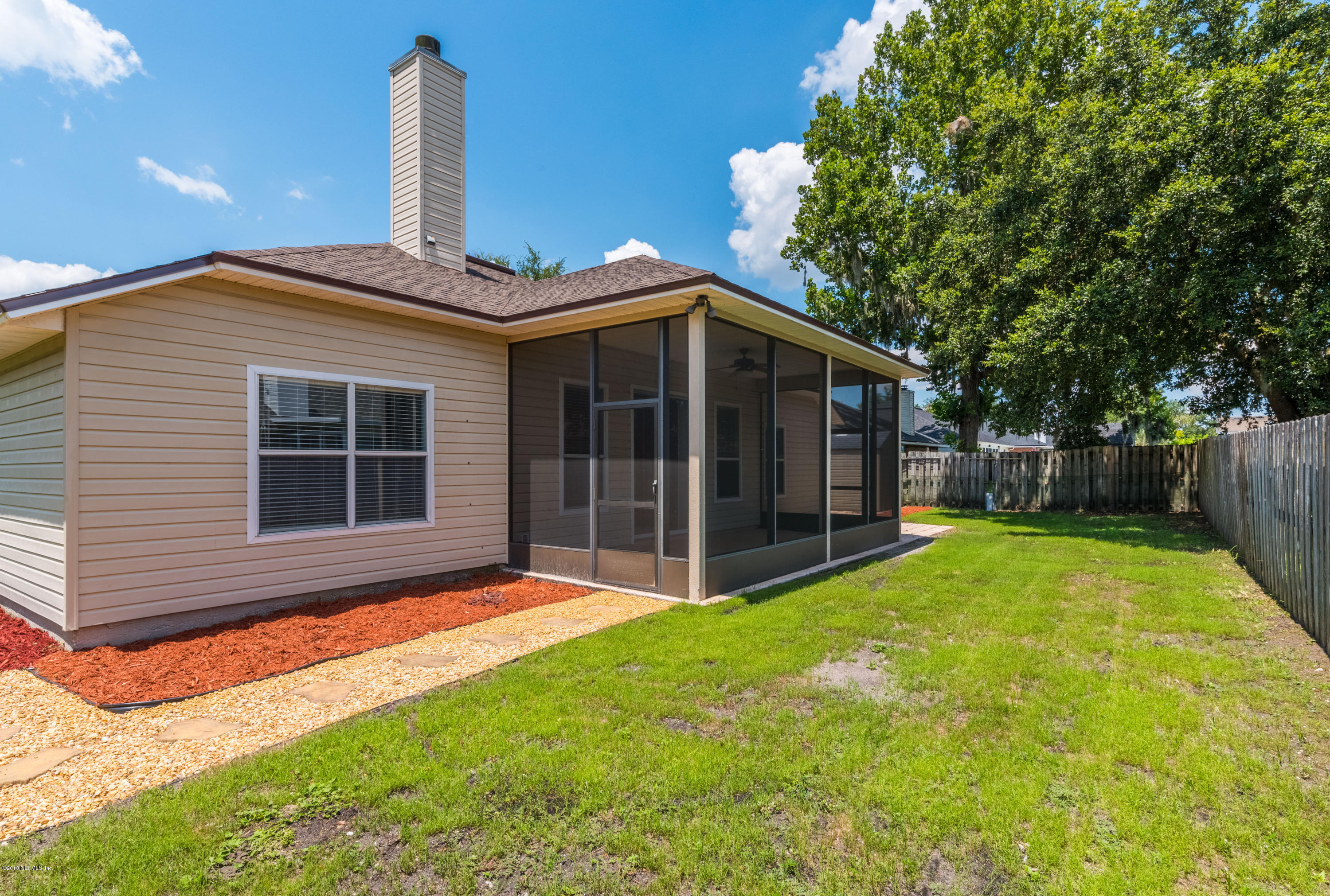 10368 Sugar Grove Road Jacksonville, FL 32221 - Photo 23 of 28 a front view of a house with a yard and garage