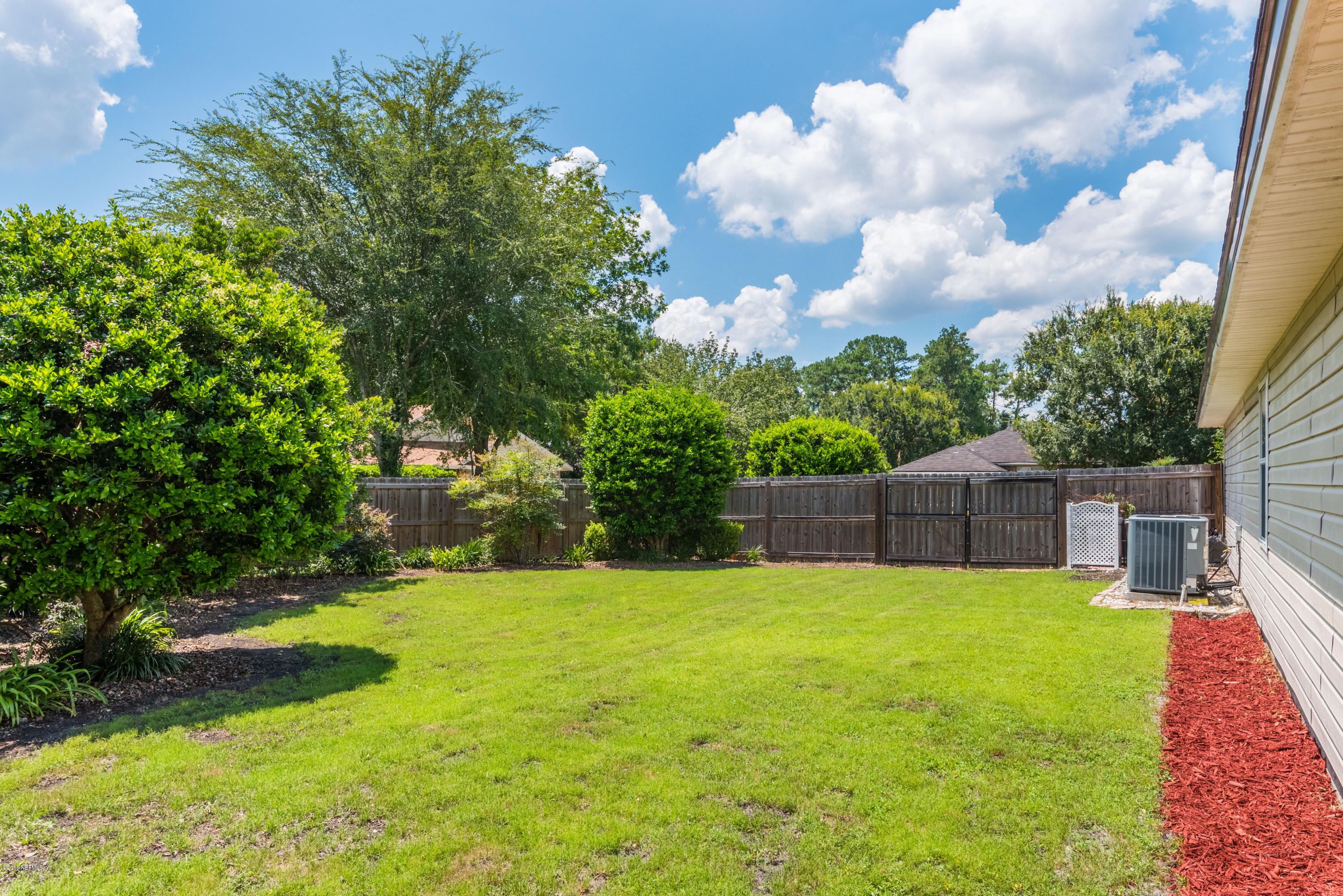 10368 Sugar Grove Road Jacksonville, FL 32221 - Photo 25 of 28 a view of backyard with a garden and trees