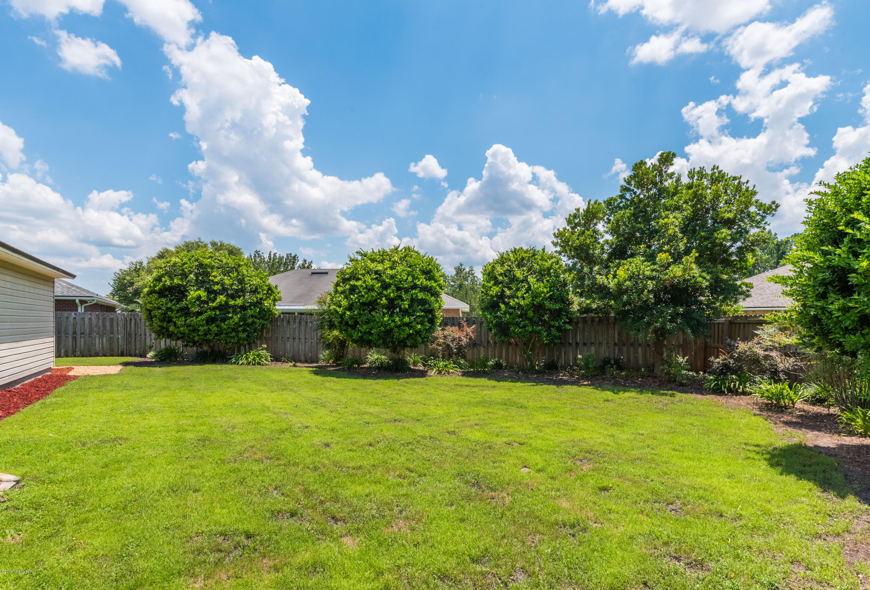 10368 Sugar Grove Road Jacksonville, FL 32221 - Photo 26 of 28 a view of a garden with a building in the background