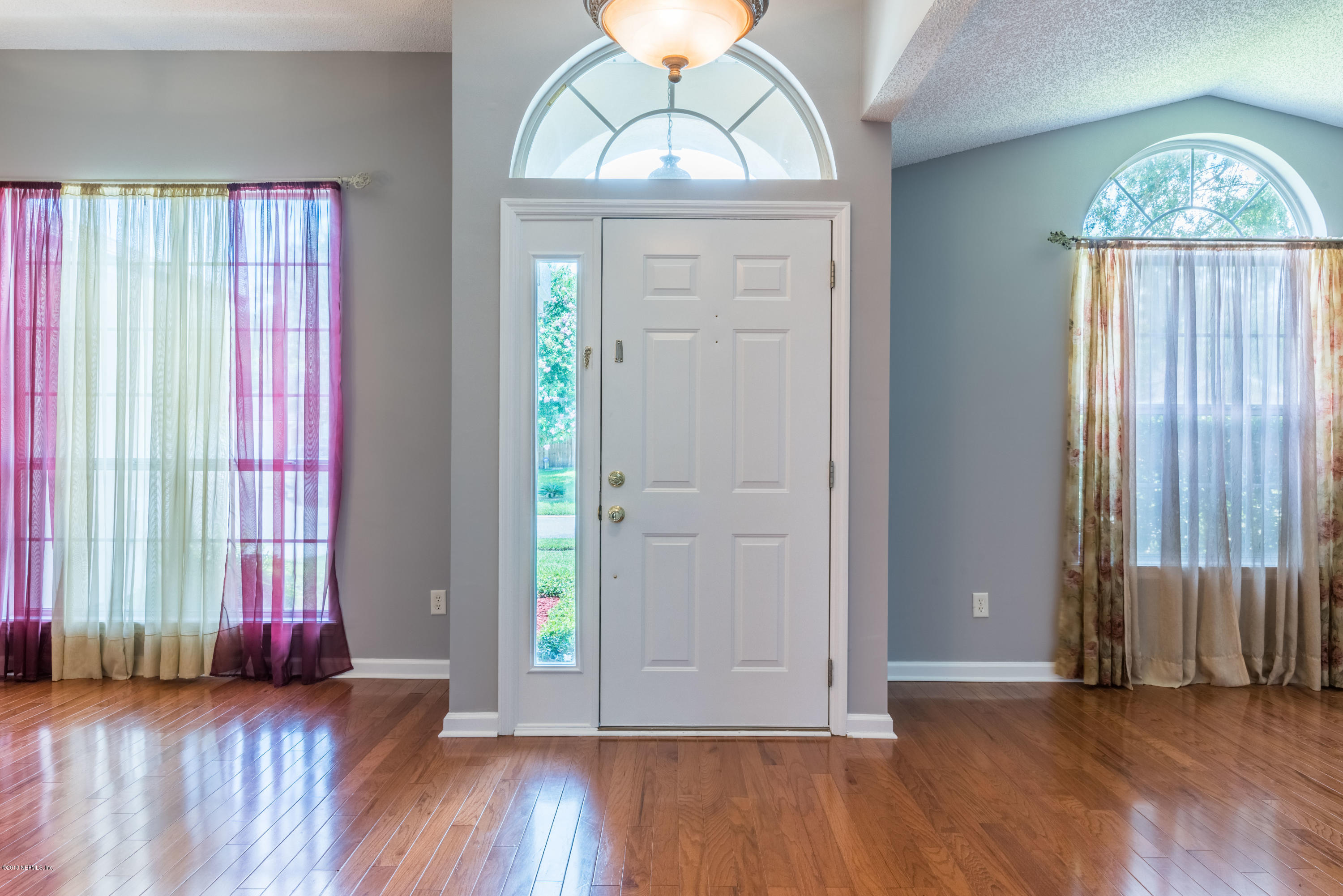 10368 Sugar Grove Road Jacksonville, FL 32221 - Photo 3 of 28 an empty room with wooden floor closet and windows