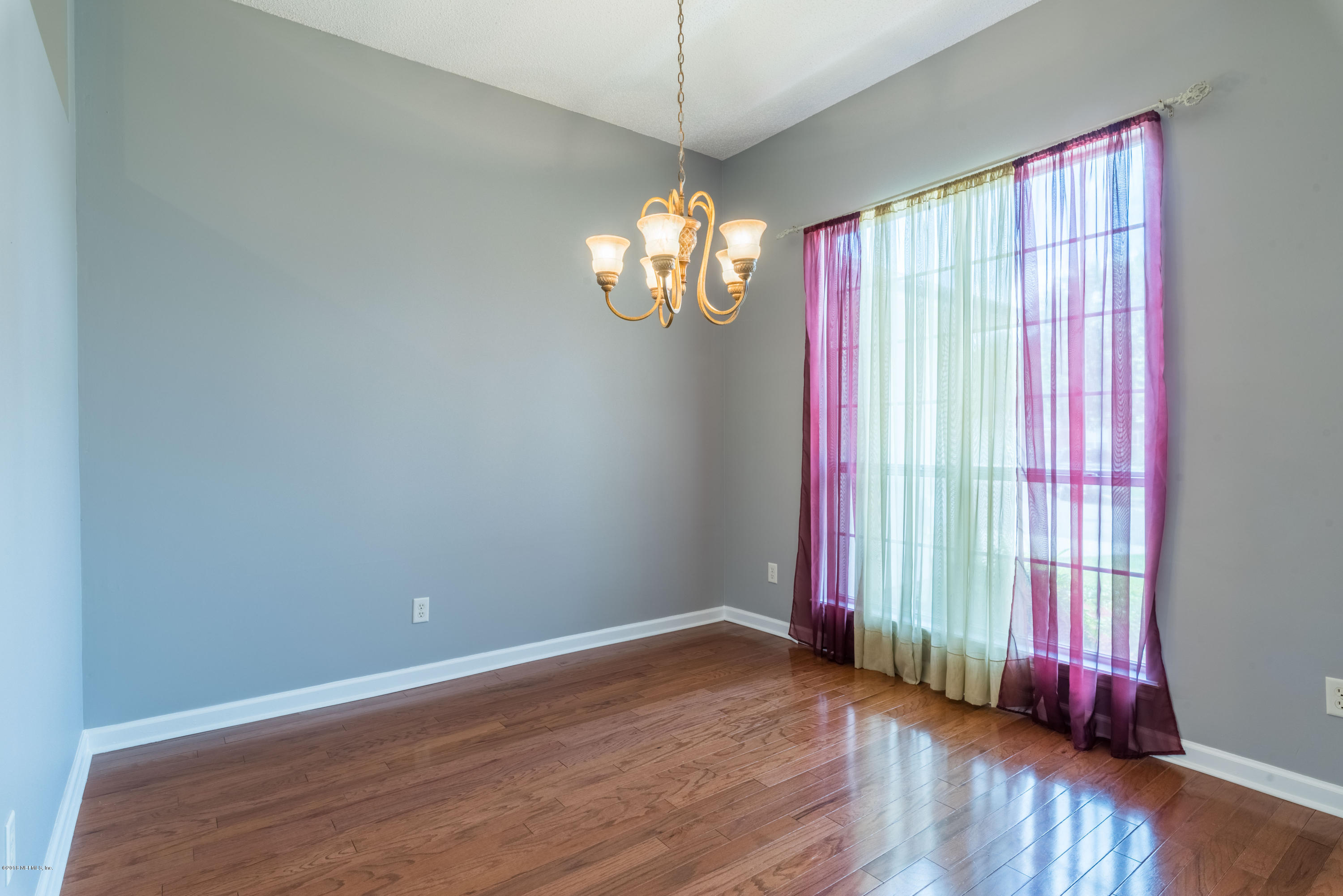 10368 Sugar Grove Road Jacksonville, FL 32221 - Photo 4 of 28 a view of a room with wooden floor and windows