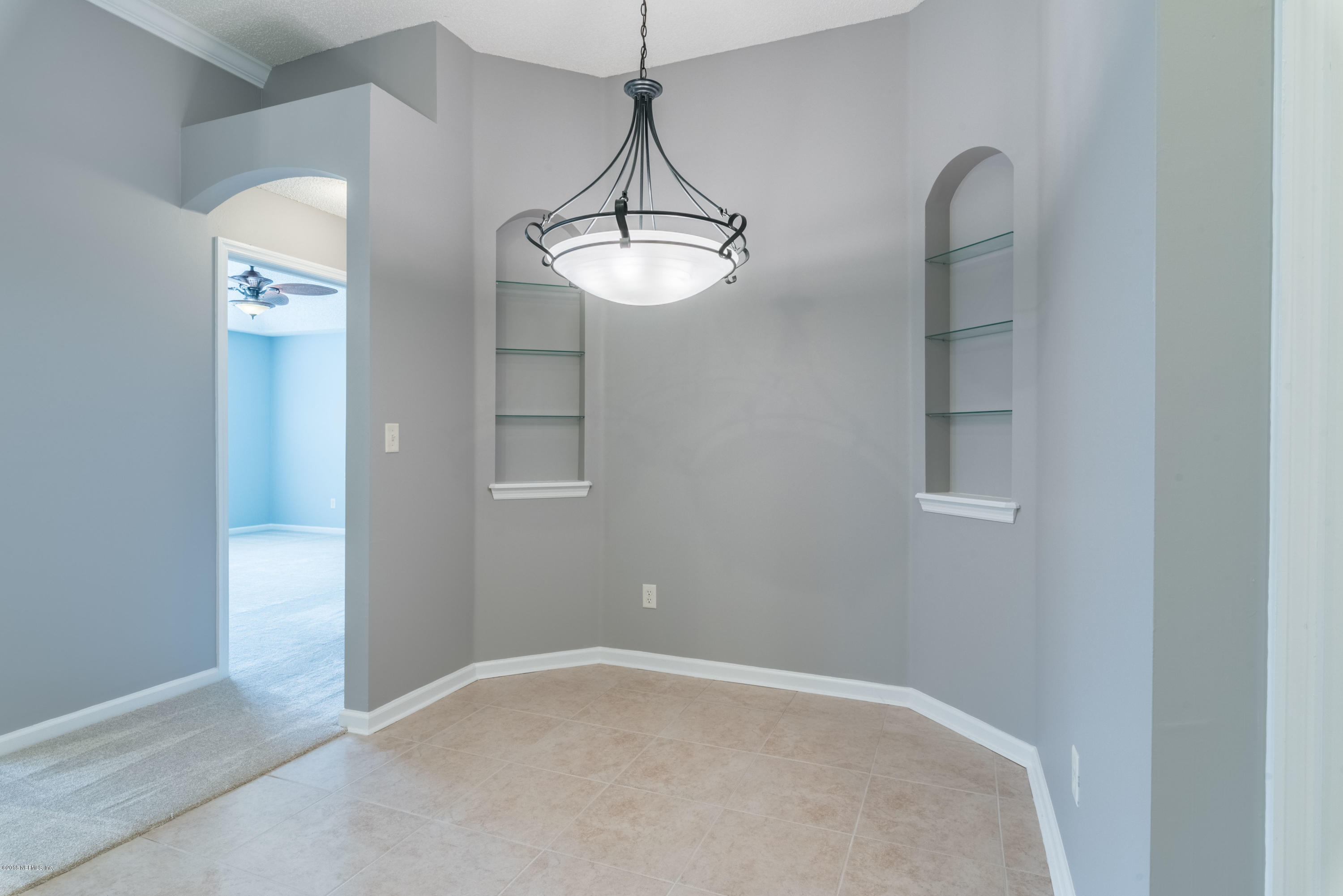 10368 Sugar Grove Road Jacksonville, FL 32221 - Photo 9 of 28 a view of a room with a hanging light and kitchen view