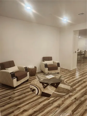 a bedroom with double bed and a couch