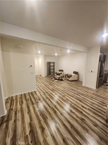 a room with lots of chairs and wooden floor