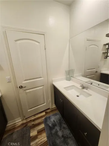 a view of a room with wooden floor and bathroom