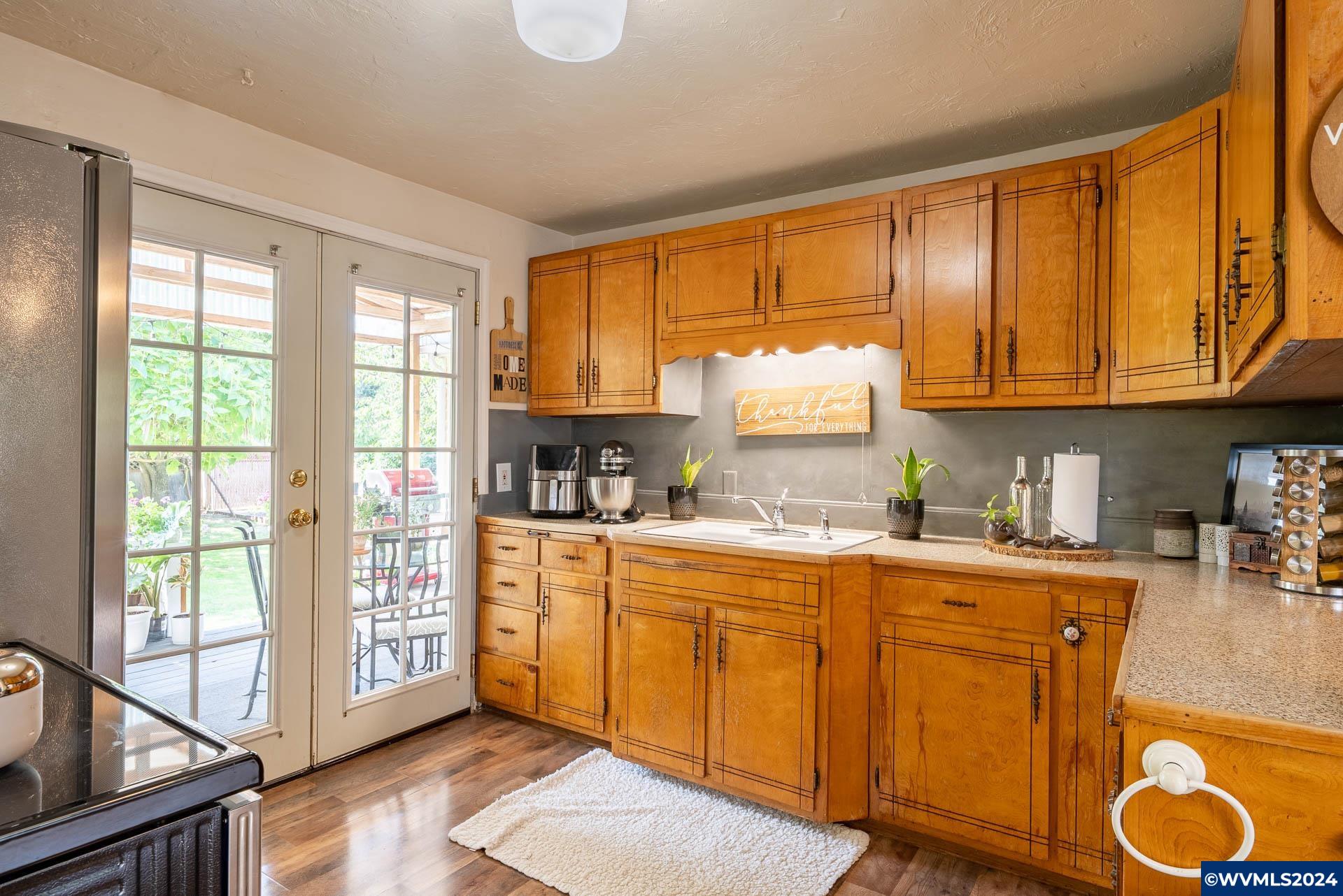 1530 2nd Avenue Albany, OR 97321 - Photo 13 of 35 a kitchen with granite countertop a stove a sink and a cabinets