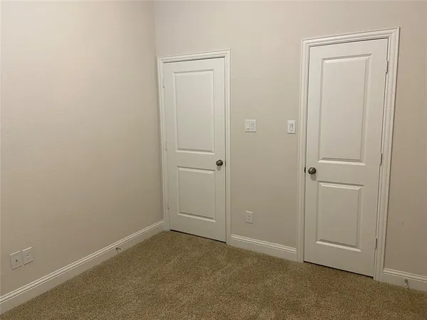 an empty room with closet area