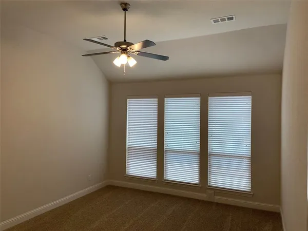 a view of a livingroom with a ceiling fan and window