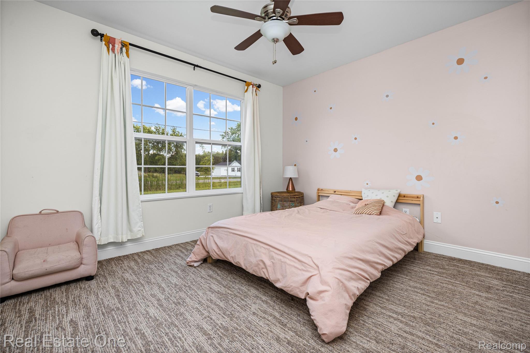 2479 Gibson Road Grand Blanc, MI 48439 - Photo 36 of 55 Broad window with grid pattern, neutral wall paint, patterned wall accent, ceiling fan, and patterned carpet flooring