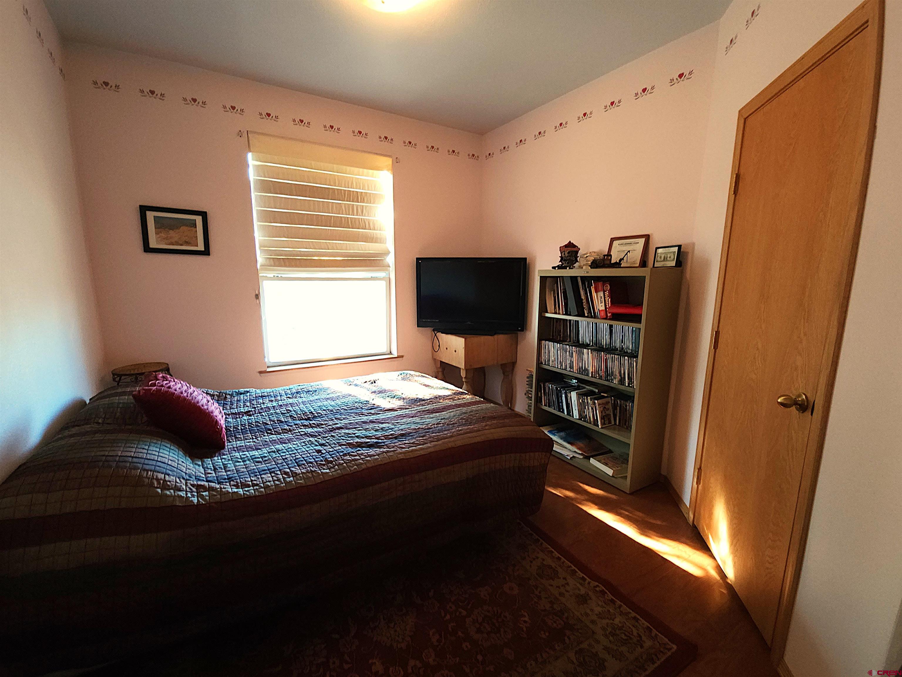 323 Holiday Overlook Crestone, CO 81131 - Photo 8 of 30 a bedroom with a bed and a book shelf