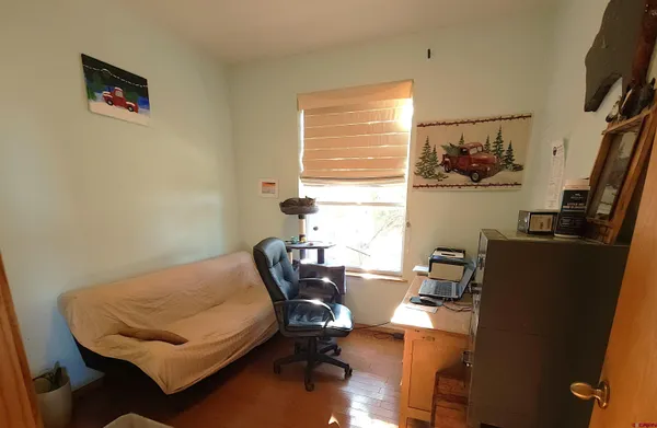 a bedroom with a bed and a book shelf
