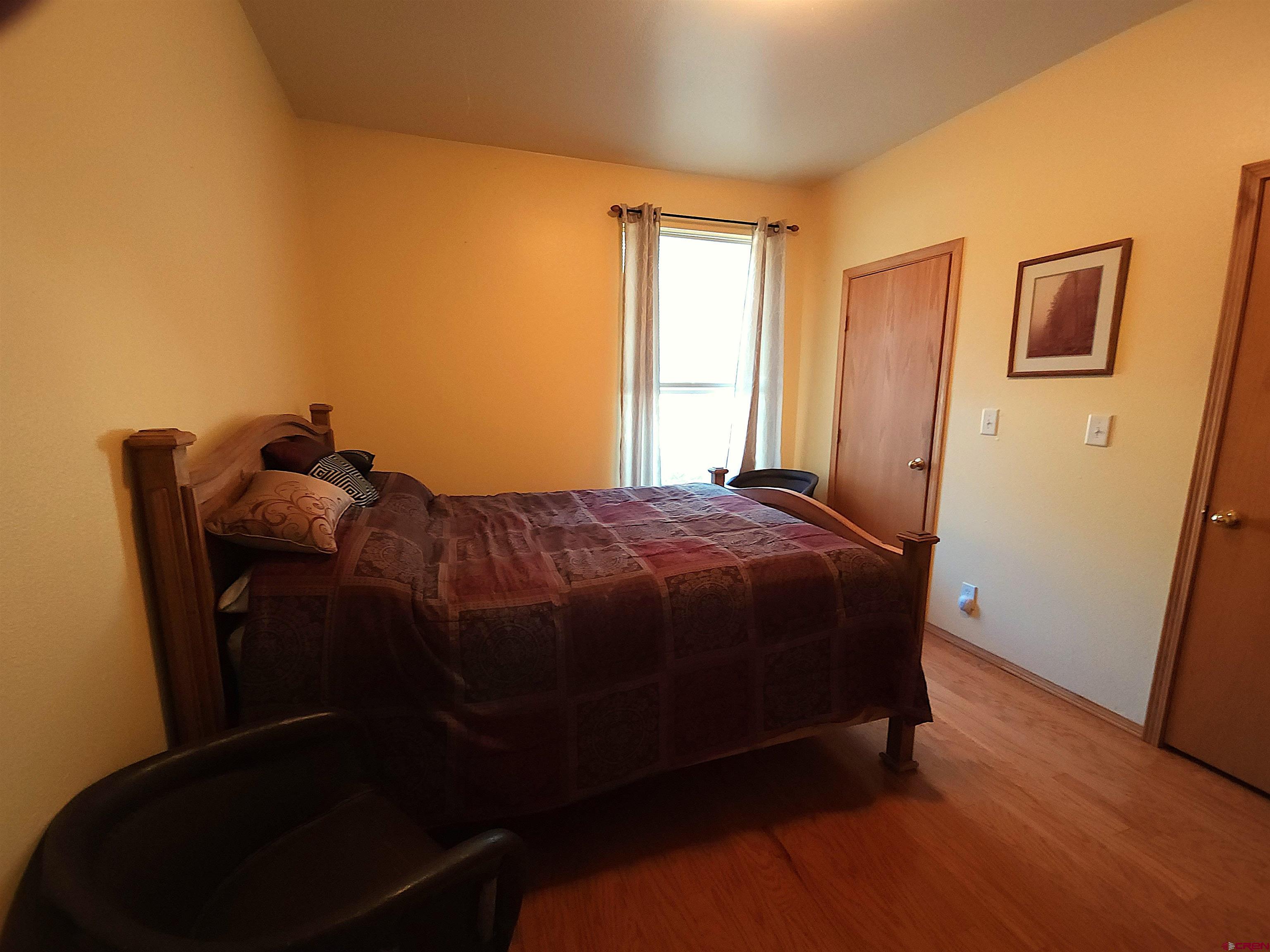 323 Holiday Overlook Crestone, CO 81131 - Photo 9 of 30 a bed sitting in a bedroom next to a window