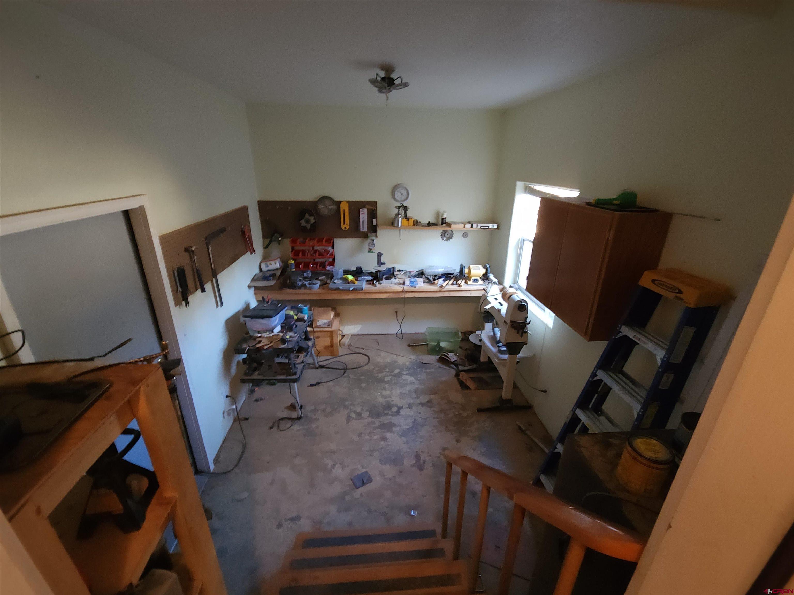 323 Holiday Overlook Crestone, CO 81131 - Photo 10 of 30 a bed room with furniture and a chair