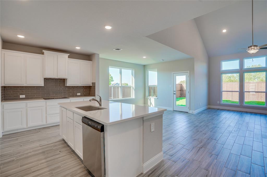 8526 Royal Star Road Rowlett, TX 75089 - Photo 12 of 21 a large kitchen with granite countertop a large counter top a sink stainless steel appliances and cabinets