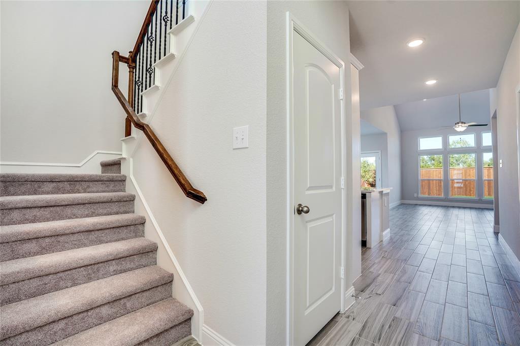 8526 Royal Star Road Rowlett, TX 75089 - Photo 18 of 21 a view of a hallway with wooden floor and staircase