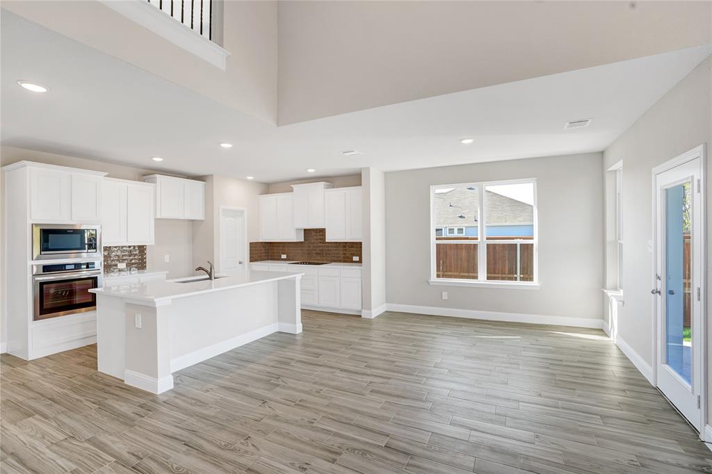8526 Royal Star Road Rowlett, TX 75089 - Photo 5 of 21 a kitchen with stainless steel appliances a refrigerator and a stove top oven
