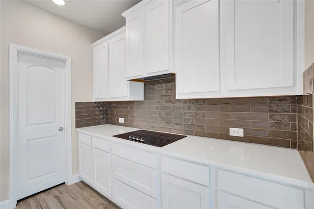 a kitchen with a sink and cabinets