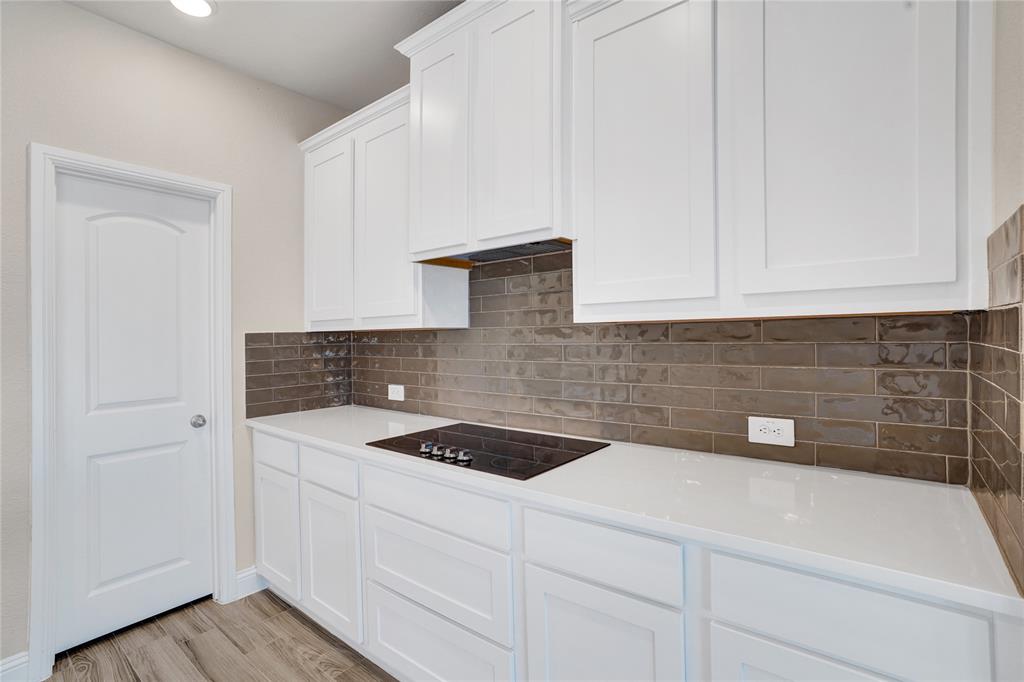 8526 Royal Star Road Rowlett, TX 75089 - Photo 7 of 21 a kitchen with a sink and cabinets