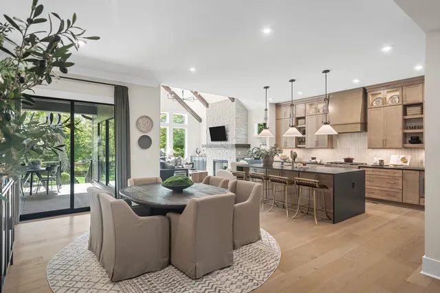 a living room with furniture a fireplace and a floor to ceiling window