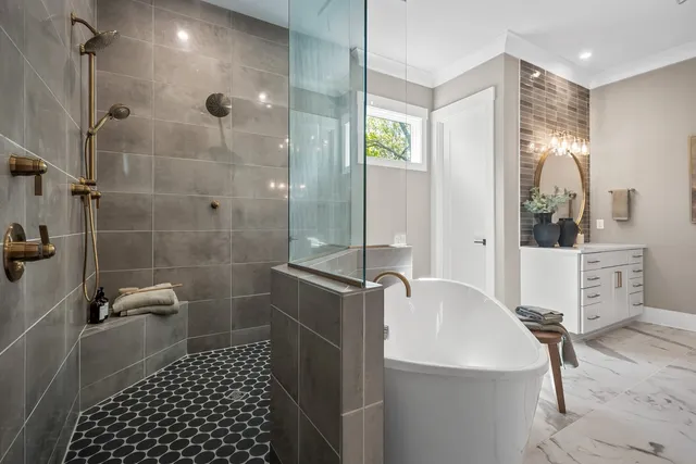 a bathroom with a sink toilet a mirror and shower