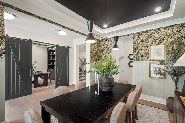 a living room with furniture and large windows