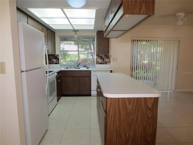 a kitchen with a refrigerator a sink and dishwasher