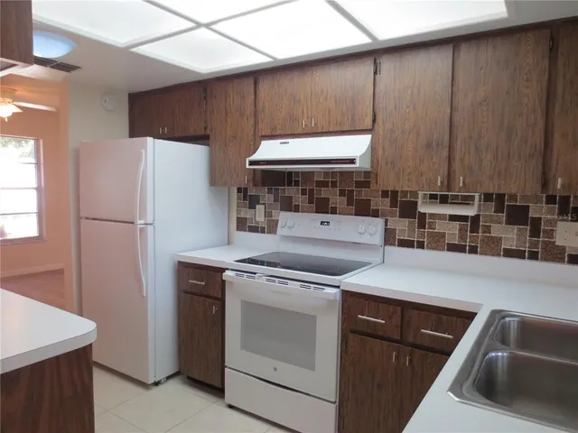 a kitchen with a stove and a refrigerator