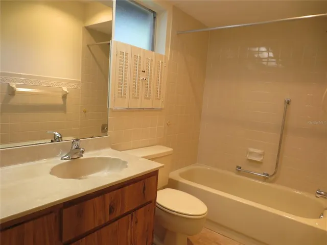 a bathroom with a sink mirror toilet and bathtub