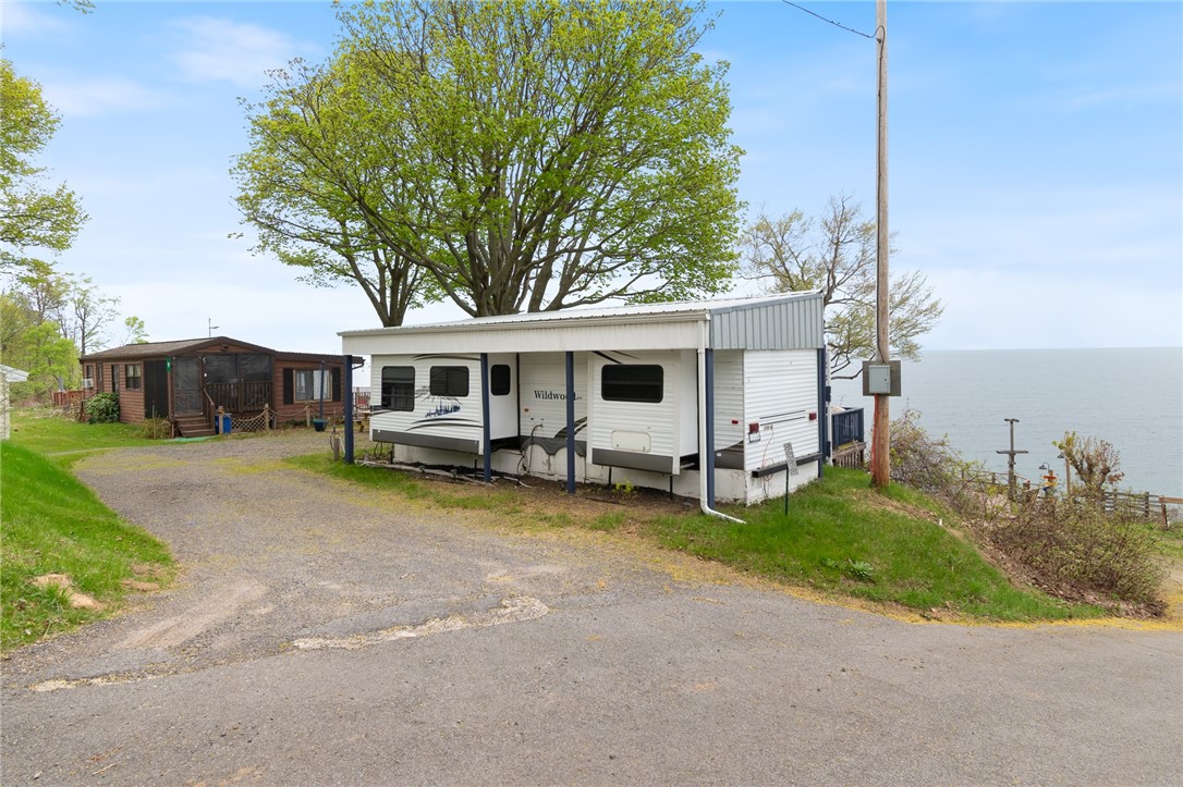 7945 Lake Road, Unit 86 Sodus, NY 14555 - Photo 4 of 22 The stone/gravel parking areas at 7945 LAKE RD #85