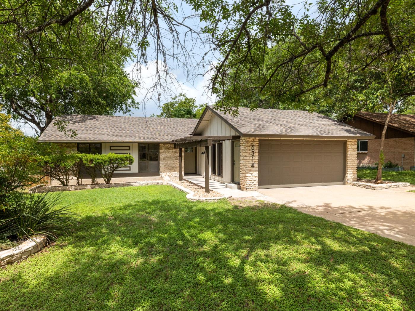 5314 Presidio Road Austin, TX 78745 - Photo 1 of 1 View of front of property featuring concrete driveway, an attached garage, roof with shingles, and a front lawn
