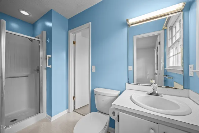 a bathroom with a toilet sink and shower