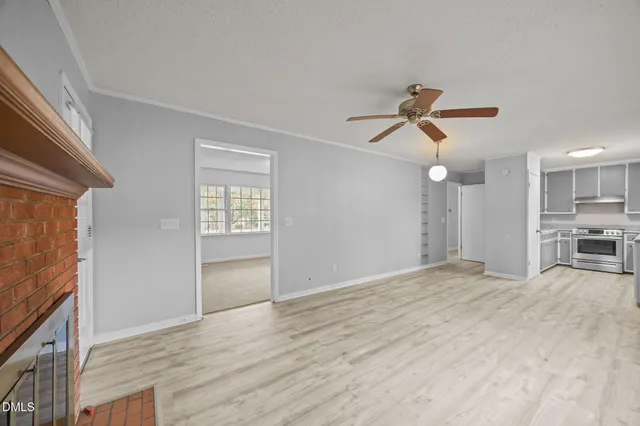 a view of an empty room with window and cabinet