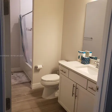 a bathroom with a glass shower door