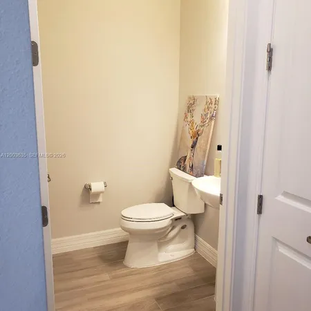 a room with a bed and a dresser