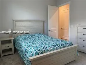 a utility room with sink dryer and cabinets