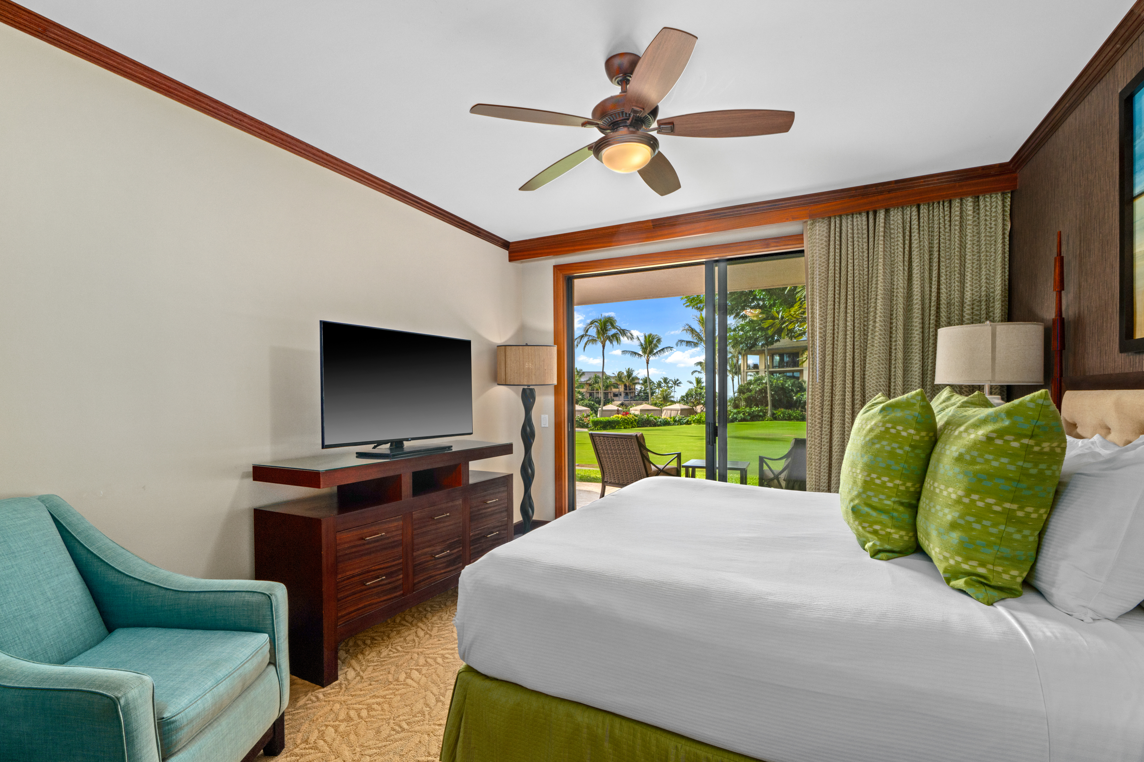 2641 Poipu Road, Unit 1107 Koloa, HI 96756 - Photo 9 of 22 a bedroom with a bed television and a large window