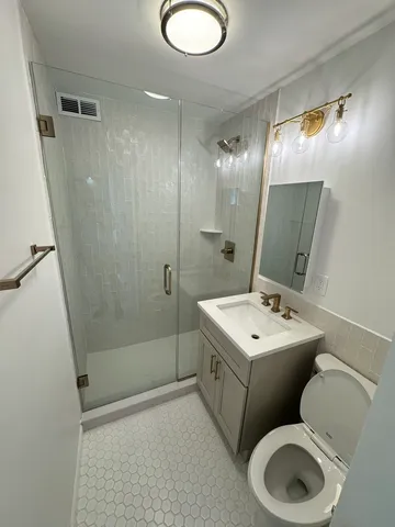 a bathroom with a toilet sink and mirror