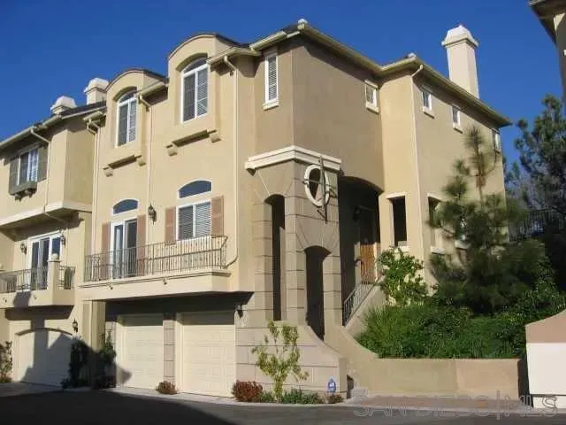 a front view of a residential apartment building with a yard