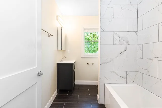 a bathroom with a bathtub and a sink