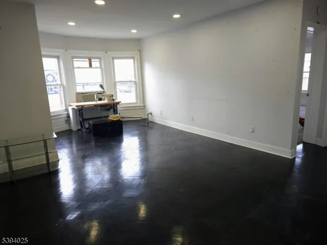 a view of a livingroom with furniture wooden floor and a window