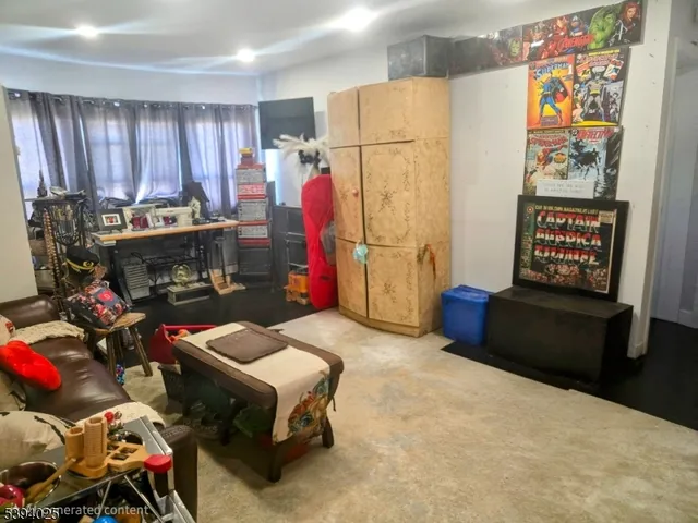 a living room with furniture a couch and a refrigerator