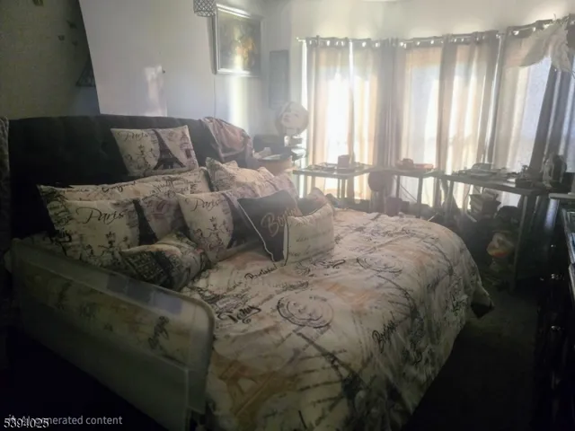 a large bed sitting in a bedroom next to a window