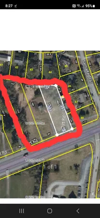 a view of a tennis ground with large trees