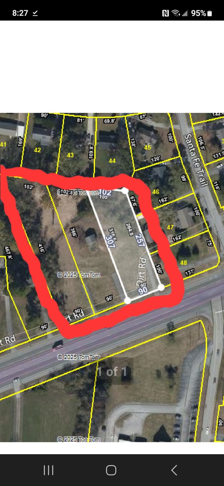 a view of a tennis ground with large trees