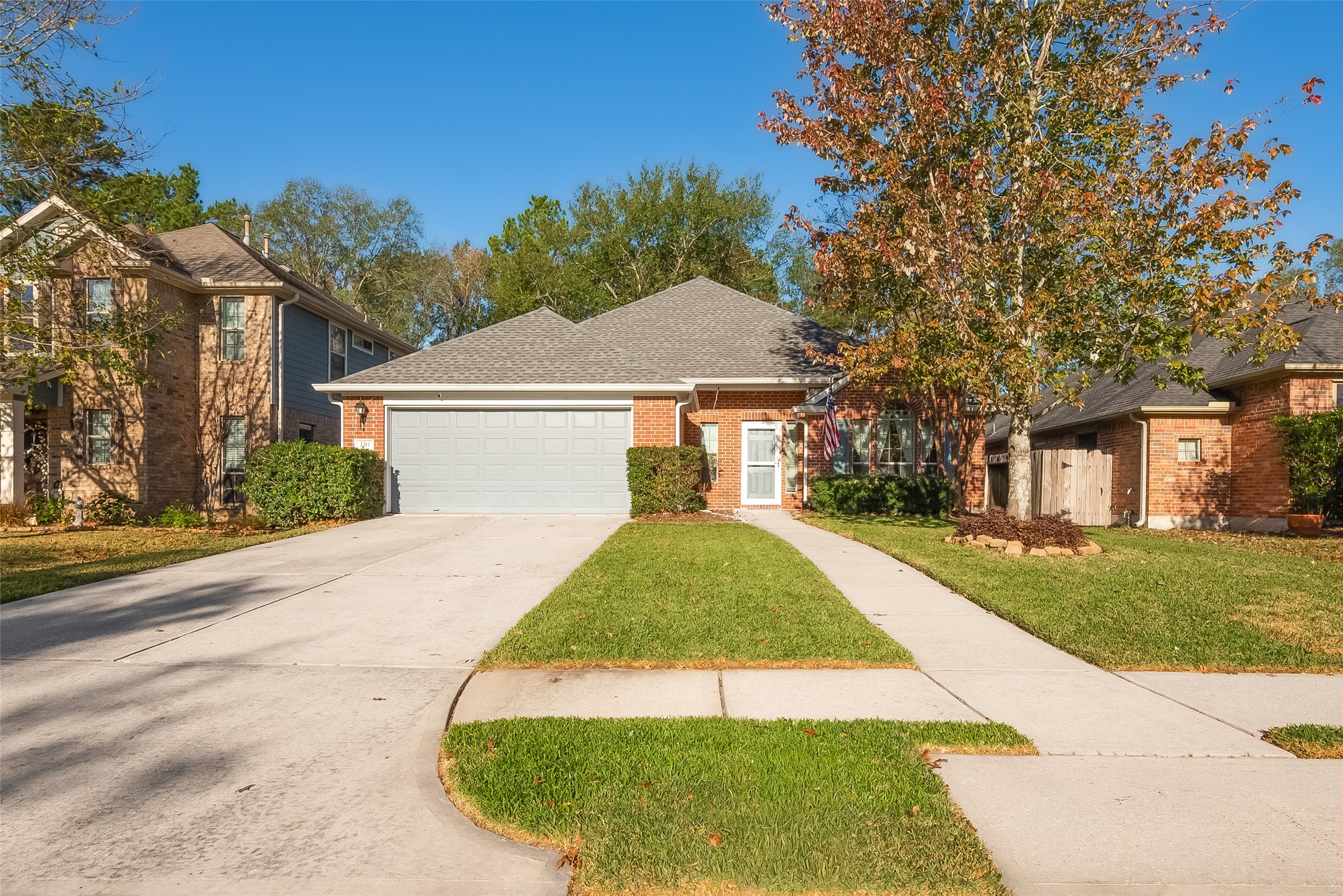 2311 Cory Crossing Lane Spring, TX 77386 - Photo 2 of 48 a view of a white house with a yard plants and large tree